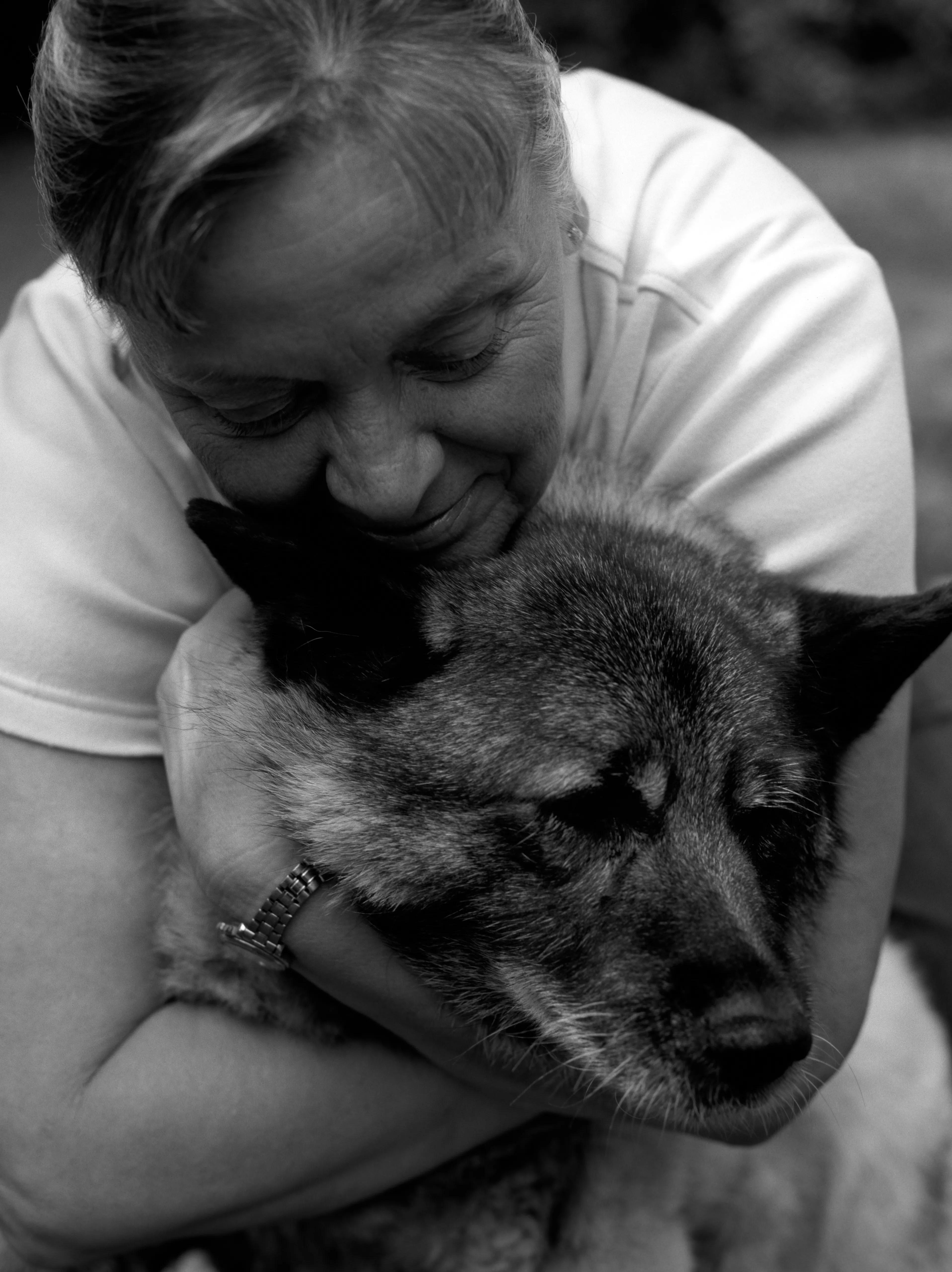 Brenda's cheek pressed to the side of Marilla's head, both in near profile, her eyes lowered. Black and white.