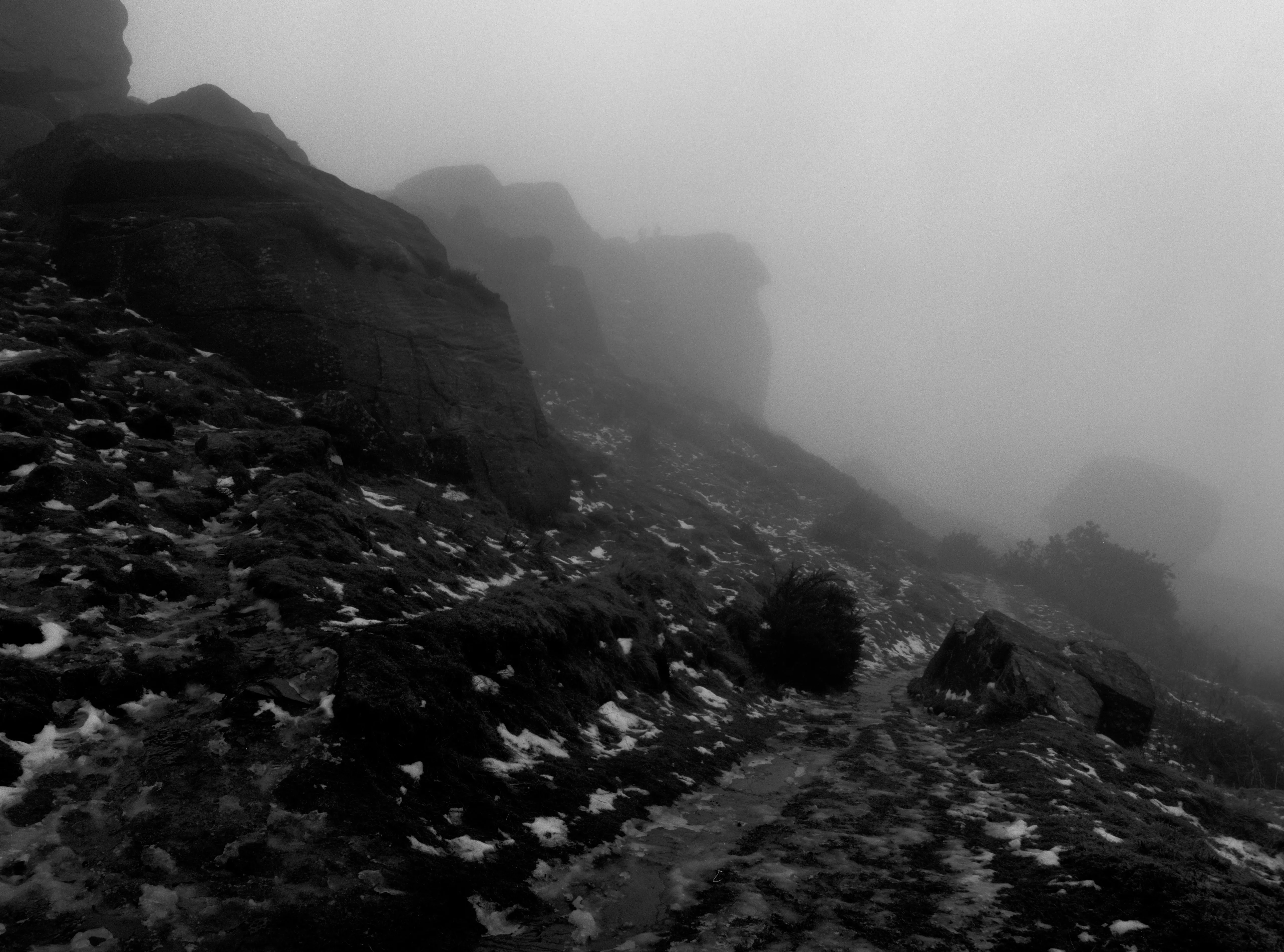 A track running away into fog, the far end gone.