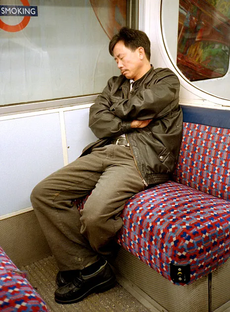 A passenger checking the time on a London Underground platform — a few more minutes to wait.
