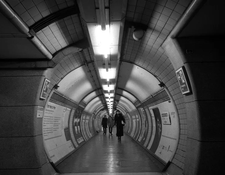 A view along a London Underground platform, the way on opening ahead.