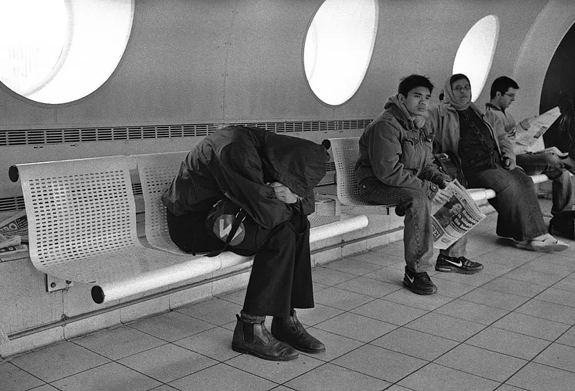 A man alone on his platform on the London Underground, the station quiet around him.