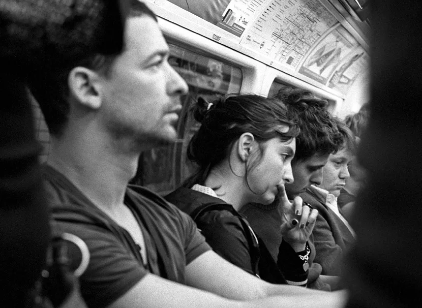 A passenger withdrawn into private thought on the London Underground.