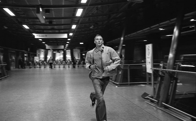 A passenger hurrying to catch a departing Underground train.