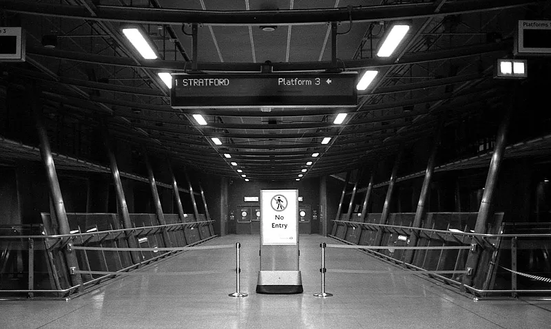 A lone traveller on the Underground late in the day, the journey home stalled.