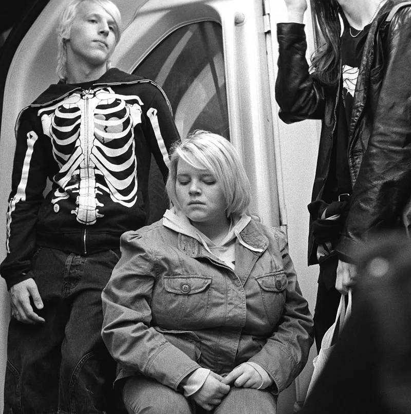 A figure hesitating on a London Underground platform, uncertain.