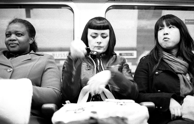 A stern-faced commuter on the London Underground.